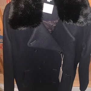 Navy pea coat with black fur and leather detail.